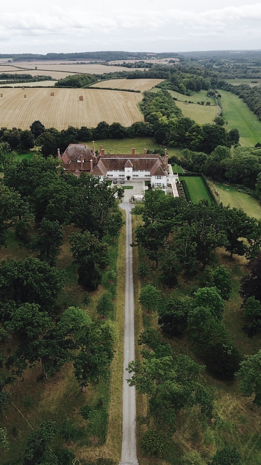 Fountain and reflecting pool framed by topiary and balustrades at Marshcourt